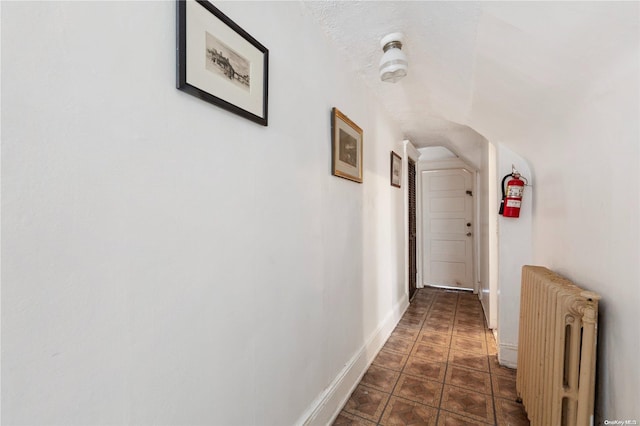 corridor with a textured ceiling and radiator