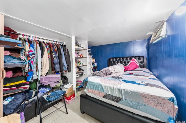 bedroom with wood walls