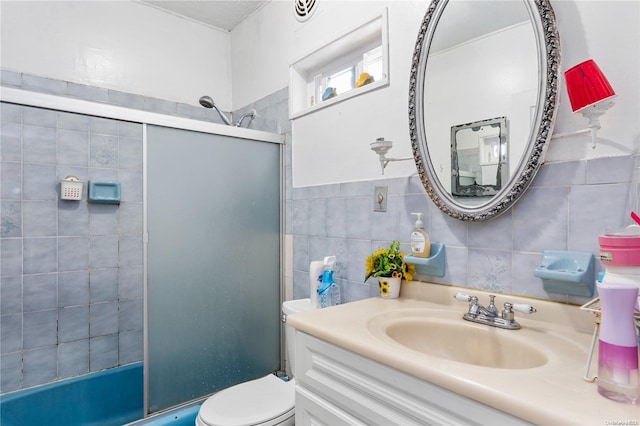 bathroom with vanity, tasteful backsplash, toilet, and tile walls