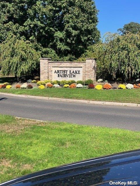 community / neighborhood sign with a lawn