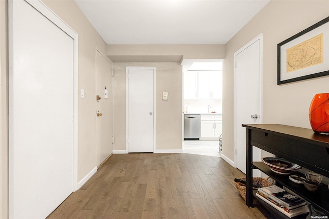 hallway with light hardwood / wood-style flooring