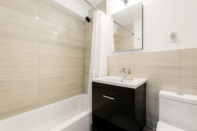 full bathroom featuring vanity, toilet, shower / bath combo with shower curtain, and tile walls