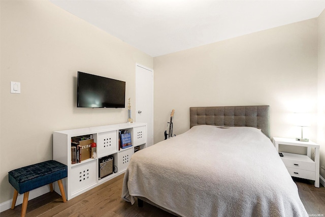 bedroom with dark wood-type flooring