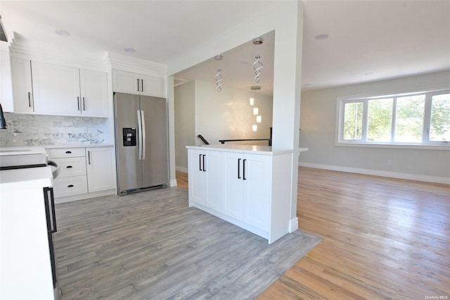 kitchen with white cabinets, light hardwood / wood-style floors, and stainless steel fridge with ice dispenser