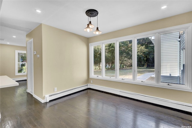 unfurnished room with a chandelier, dark wood-type flooring, and a baseboard heating unit