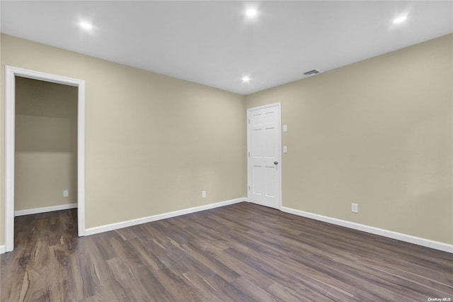 unfurnished room featuring dark hardwood / wood-style flooring