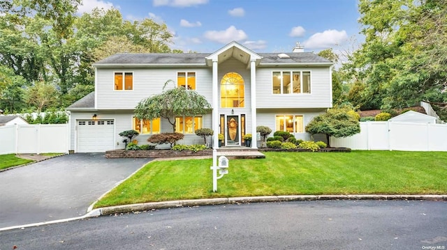 view of front of house featuring a garage and a front yard