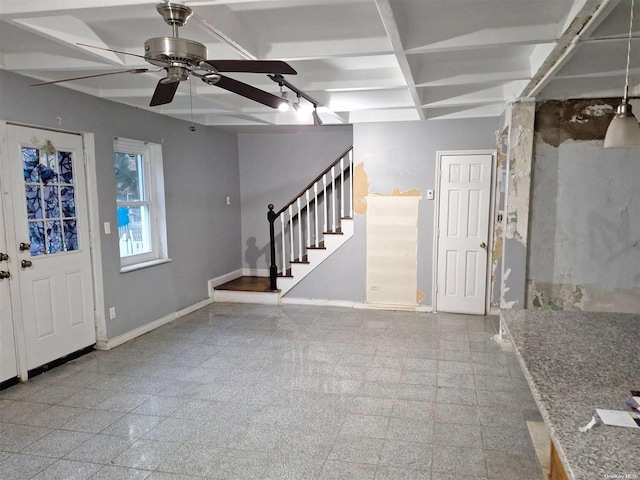 foyer entrance with beamed ceiling, ceiling fan, and coffered ceiling