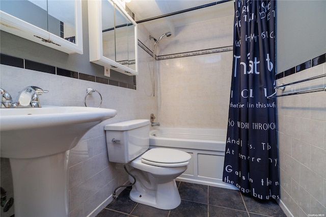 bathroom with tile patterned floors, shower / bath combination with curtain, tile walls, and toilet