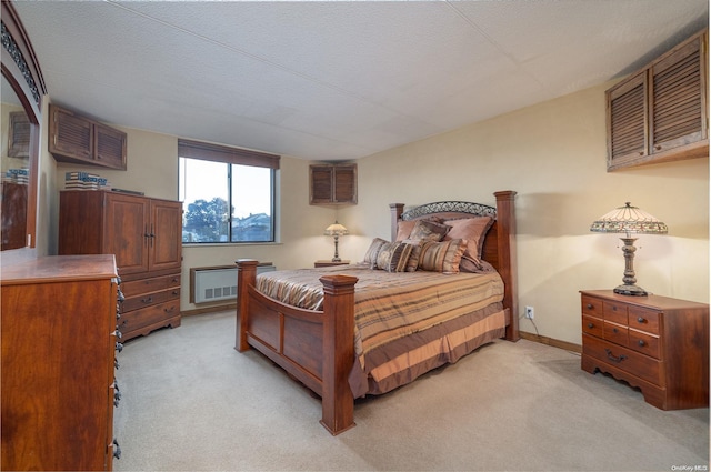 bedroom with a textured ceiling and light carpet