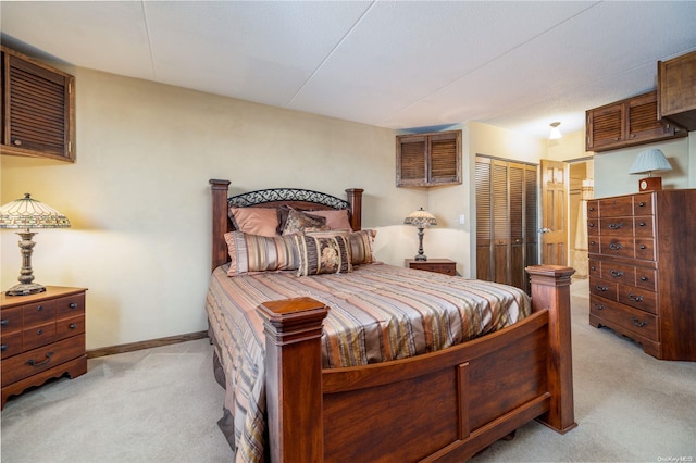 bedroom featuring light colored carpet and ensuite bath