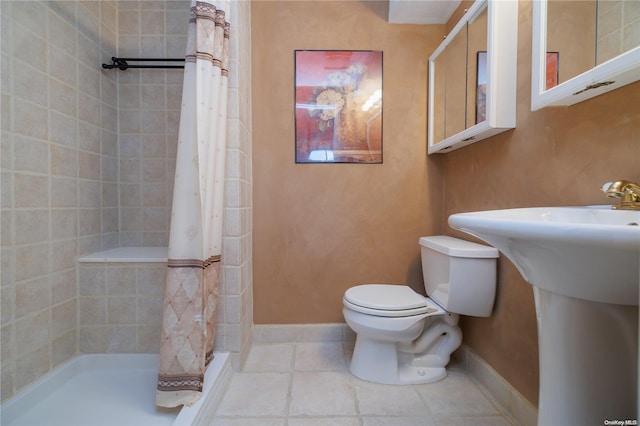 bathroom with curtained shower, tile patterned flooring, and toilet