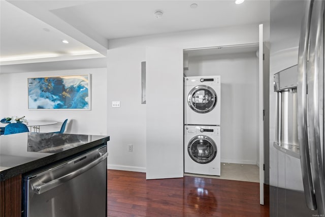 washroom featuring dark hardwood / wood-style flooring and stacked washing maching and dryer