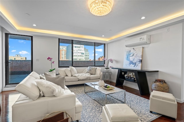 interior space with an AC wall unit, a raised ceiling, dark hardwood / wood-style floors, and an inviting chandelier