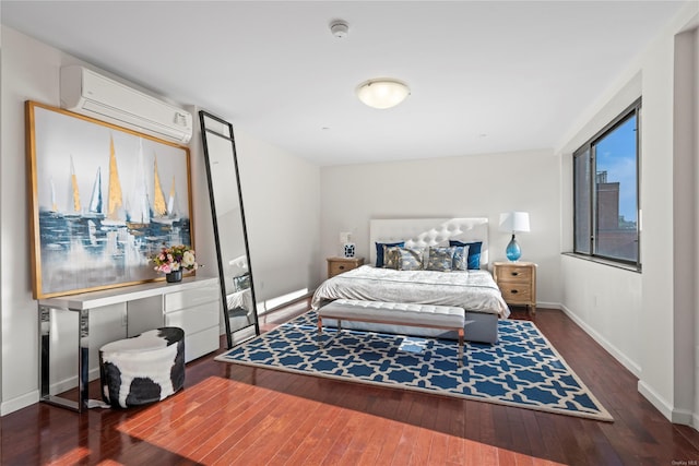 bedroom with a wall unit AC and dark wood-type flooring