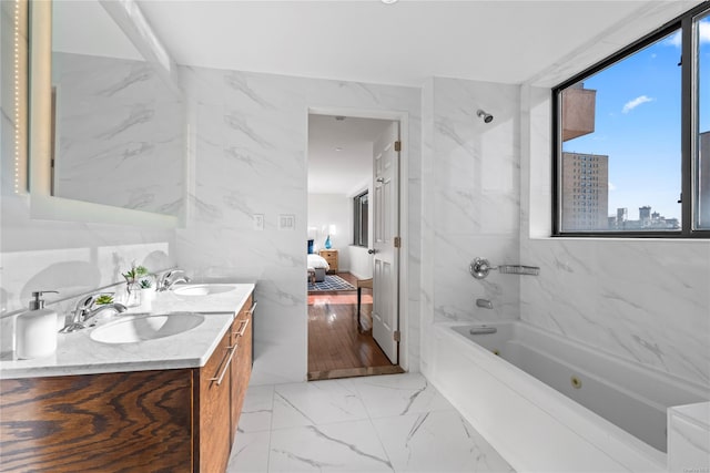 bathroom featuring vanity and tiled shower / bath combo