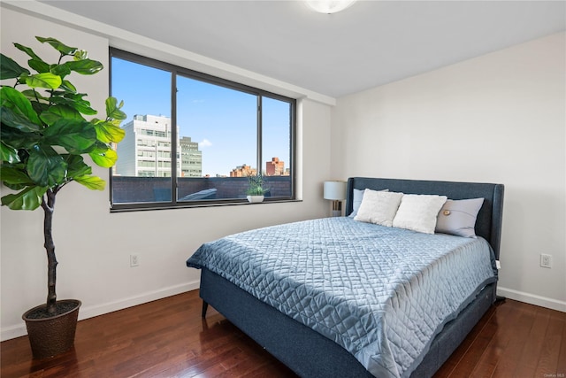 bedroom with dark wood-type flooring