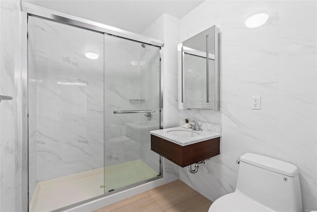 bathroom featuring sink, toilet, tile walls, and an enclosed shower