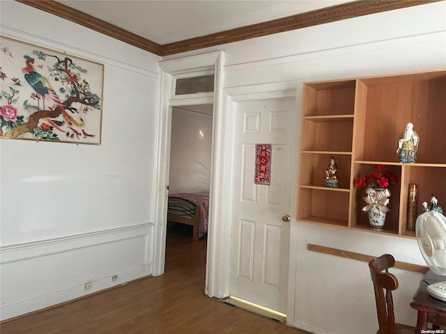 corridor featuring dark wood-type flooring and ornamental molding