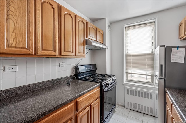 kitchen featuring decorative backsplash, stainless steel fridge, radiator, gas stove, and light tile patterned floors