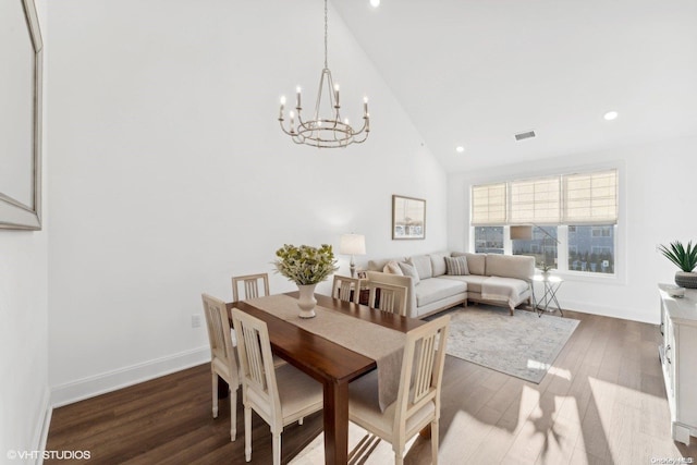 dining room featuring a chandelier, high vaulted ceiling, and dark wood-type flooring