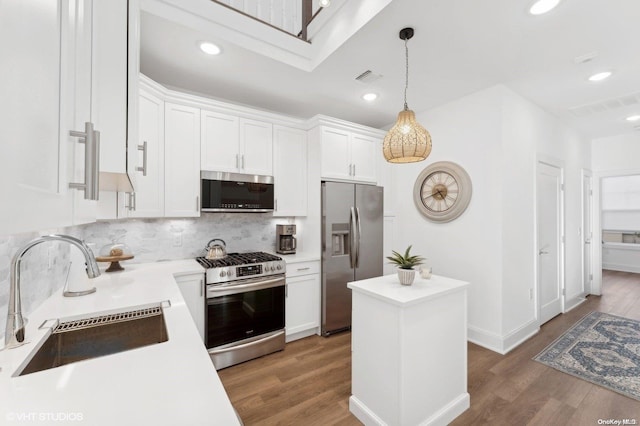 kitchen featuring dark hardwood / wood-style floors, white cabinetry, sink, and appliances with stainless steel finishes