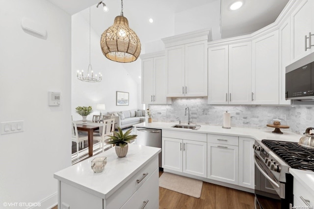 kitchen with backsplash, sink, dark hardwood / wood-style flooring, white cabinetry, and stainless steel appliances