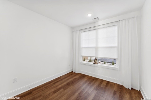 spare room featuring dark hardwood / wood-style floors