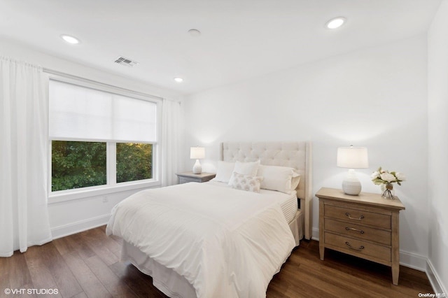 bedroom with dark hardwood / wood-style flooring