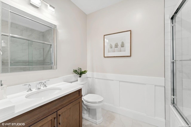 full bathroom featuring tile patterned floors, vanity, combined bath / shower with glass door, and toilet