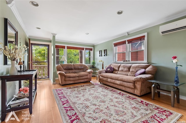 living room with light hardwood / wood-style floors, a wall mounted AC, and ornamental molding