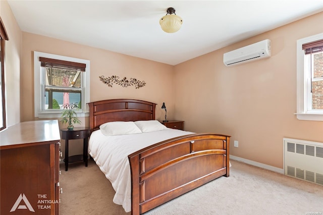 carpeted bedroom with radiator heating unit and an AC wall unit