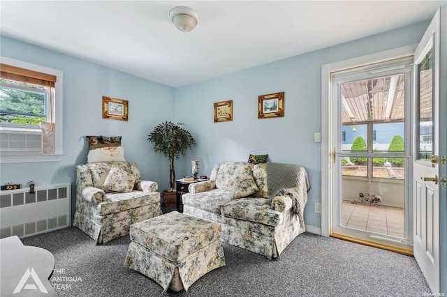 sitting room featuring carpet flooring, radiator, and cooling unit