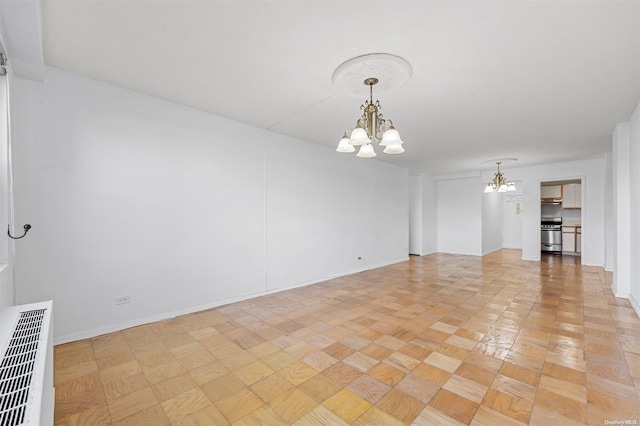 empty room with an inviting chandelier