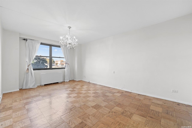 unfurnished room featuring radiator heating unit and an inviting chandelier