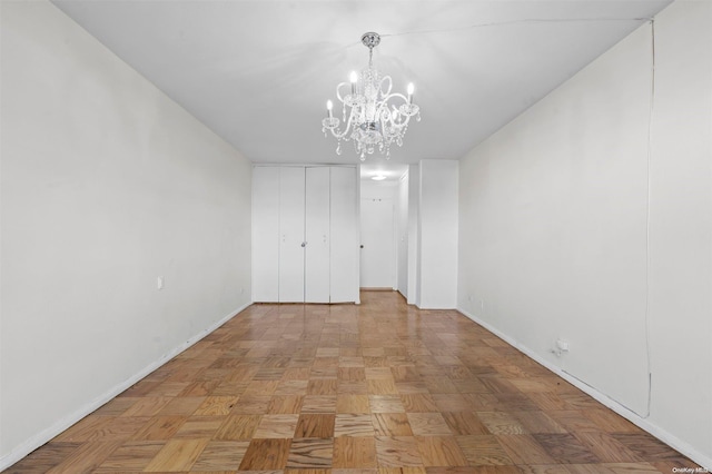 interior space with a chandelier and light parquet flooring