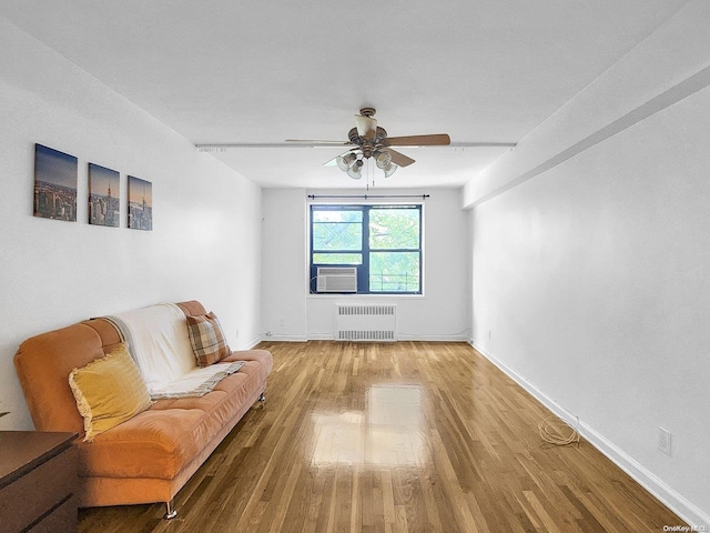 unfurnished room featuring hardwood / wood-style floors, radiator, and ceiling fan