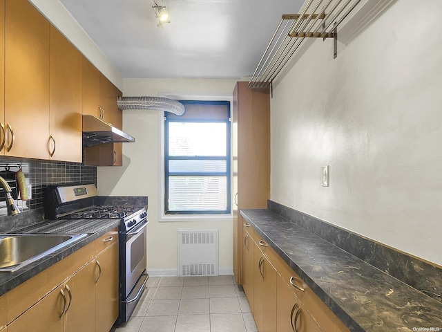 kitchen with light tile patterned flooring, sink, decorative backsplash, gas stove, and extractor fan