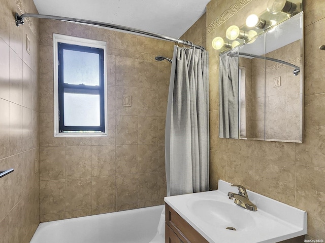 bathroom with shower / bath combo with shower curtain and vanity