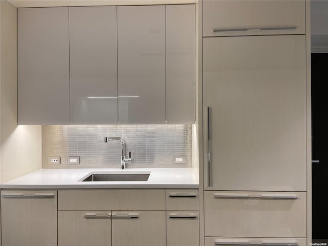 kitchen with stainless steel dishwasher, decorative backsplash, and sink