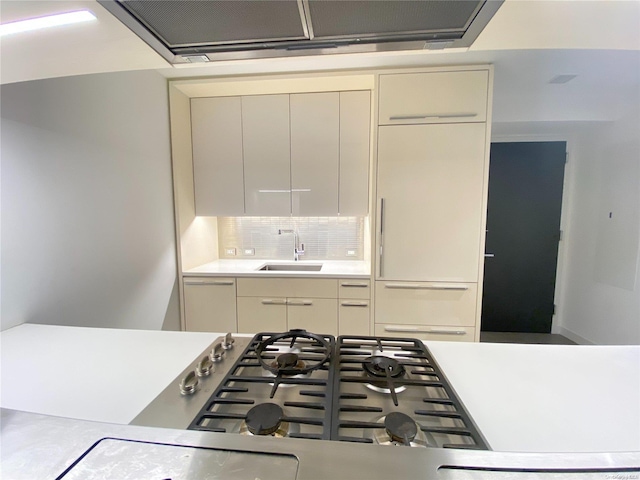 kitchen with appliances with stainless steel finishes, cream cabinets, and sink