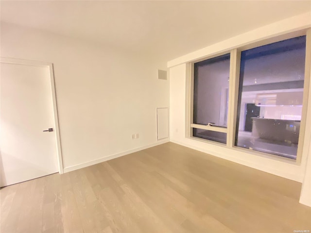 unfurnished room with hardwood / wood-style floors