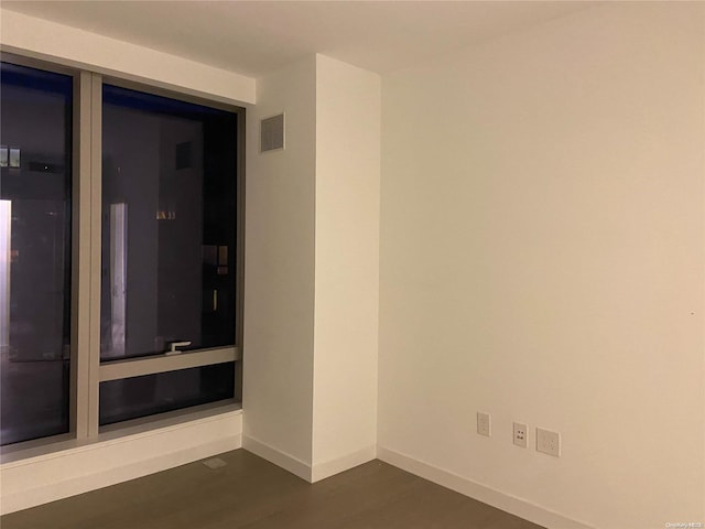 spare room with dark hardwood / wood-style floors