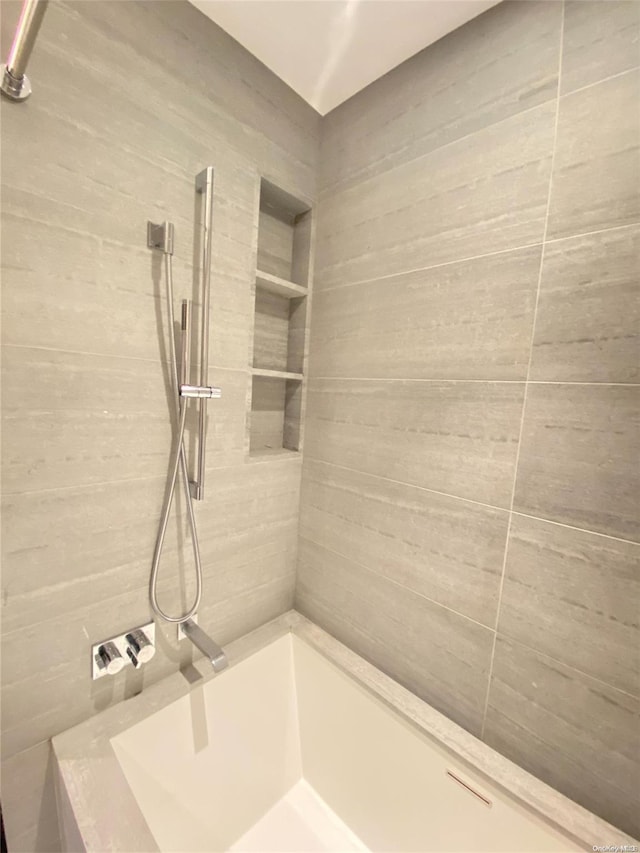 bathroom with tiled shower