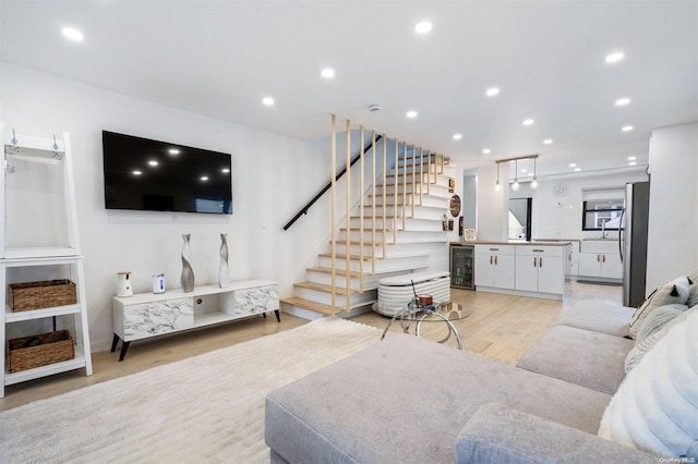 living room featuring light hardwood / wood-style floors and beverage cooler