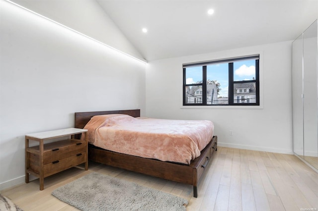 bedroom with light hardwood / wood-style flooring and vaulted ceiling