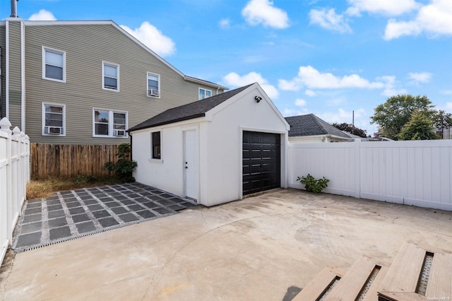 exterior space with a patio area, an outbuilding, and a garage