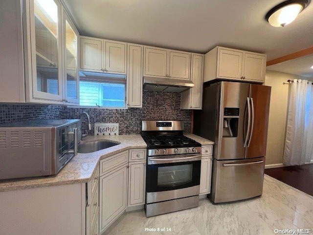 kitchen with white cabinetry, sink, extractor fan, decorative backsplash, and appliances with stainless steel finishes