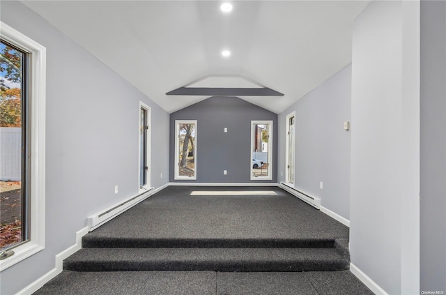 interior space with carpet, lofted ceiling, and a baseboard heating unit