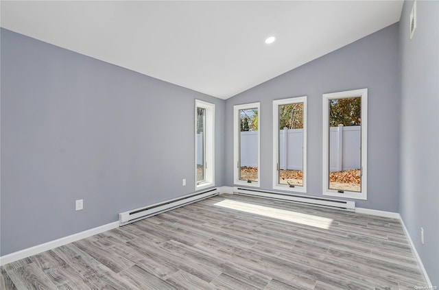 unfurnished room with light wood-type flooring, vaulted ceiling, and baseboard heating